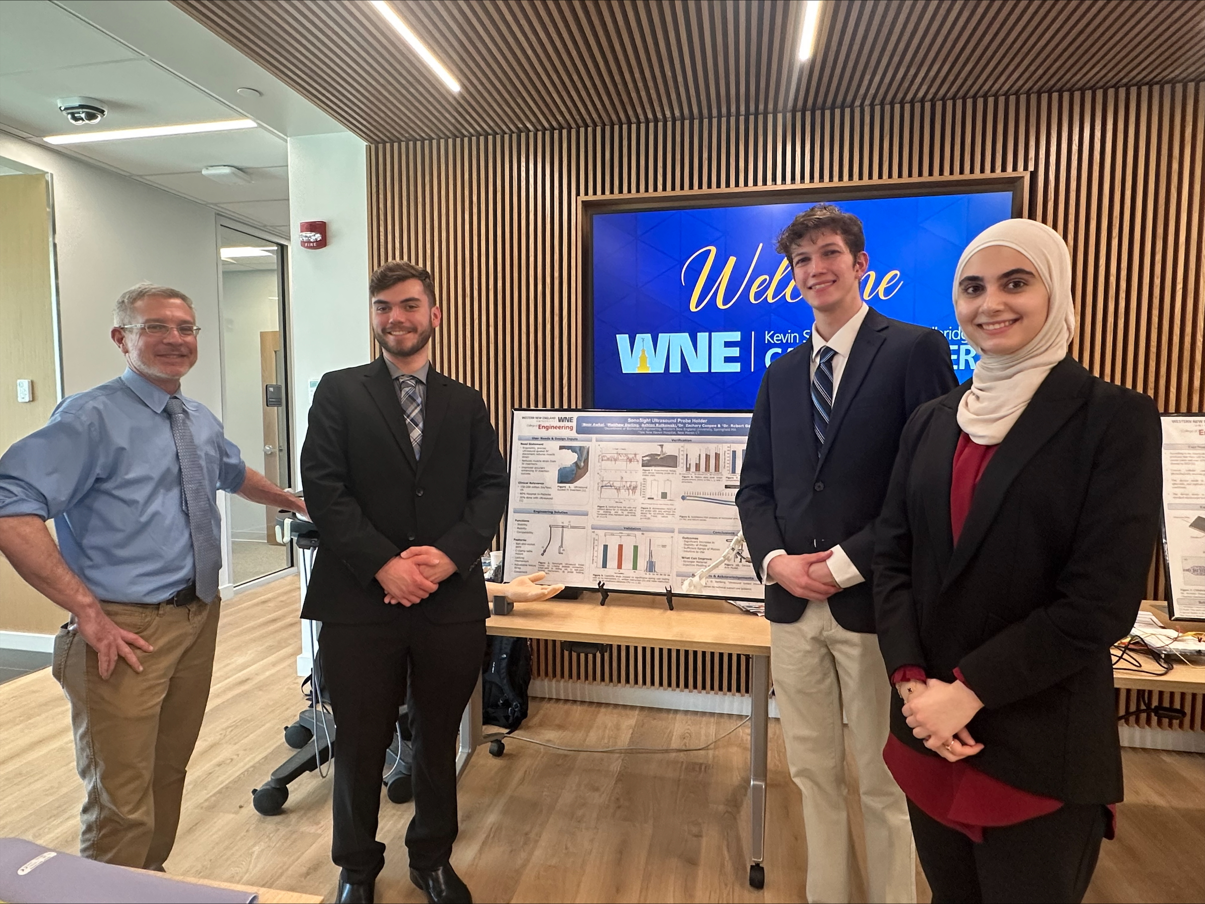 Dr. Gettens with senior design team at poster